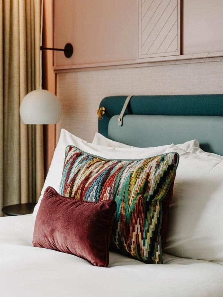 Deluxe Queen bedroom at The Halyard with pink walls and luxe details — ideal for getting ready on a hen weekend.
