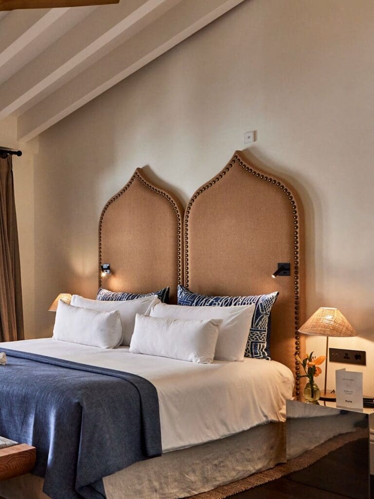 Minimal, design-led bedroom at Puro Grand Hotel with high ceilings and neutral tones — serene base for a girls’ weekend.