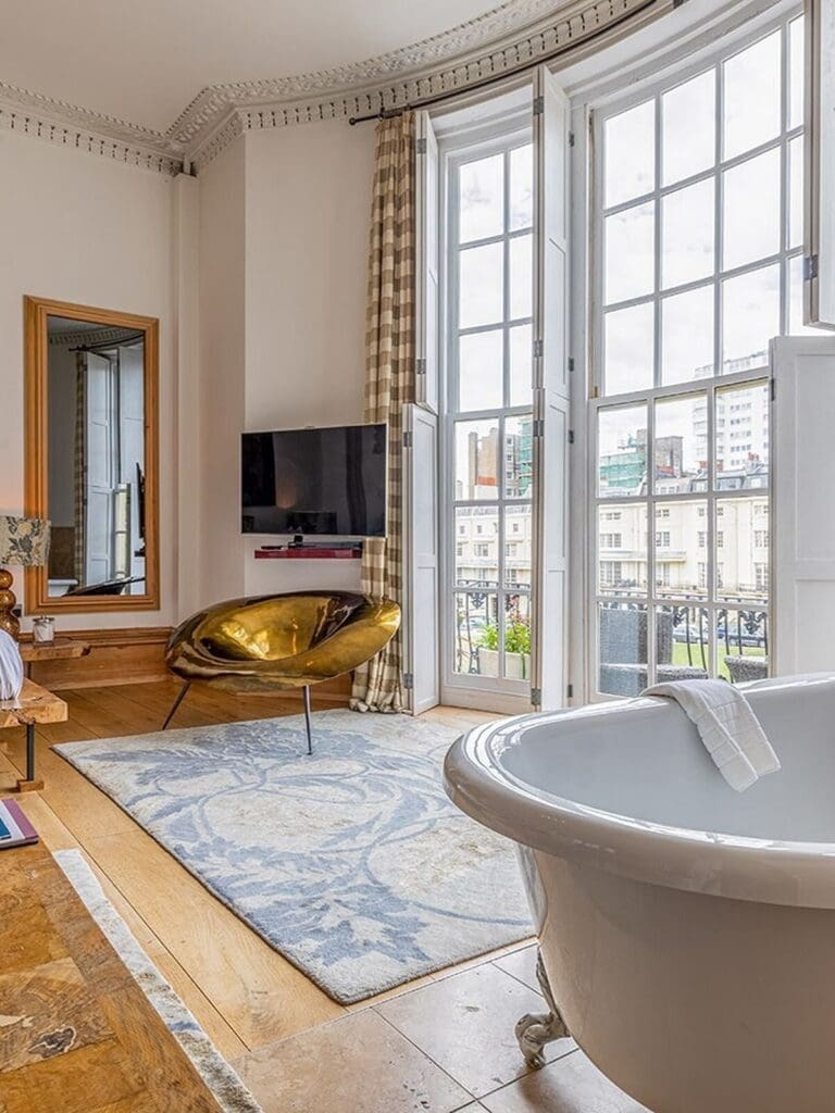 Hotel Una Brighton bedroom with curated boutique design and freestanding bath, perfect for a girls’ weekend.