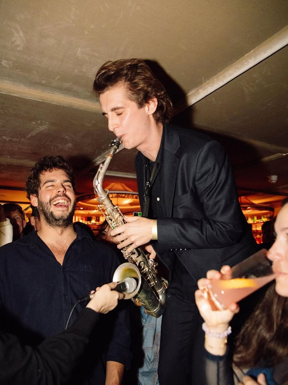 Live saxophonist performing at The Alligator Bar inside House of Louis in London, with guests dancing and cocktails flowing — a high-energy stop on a London hen weekend.