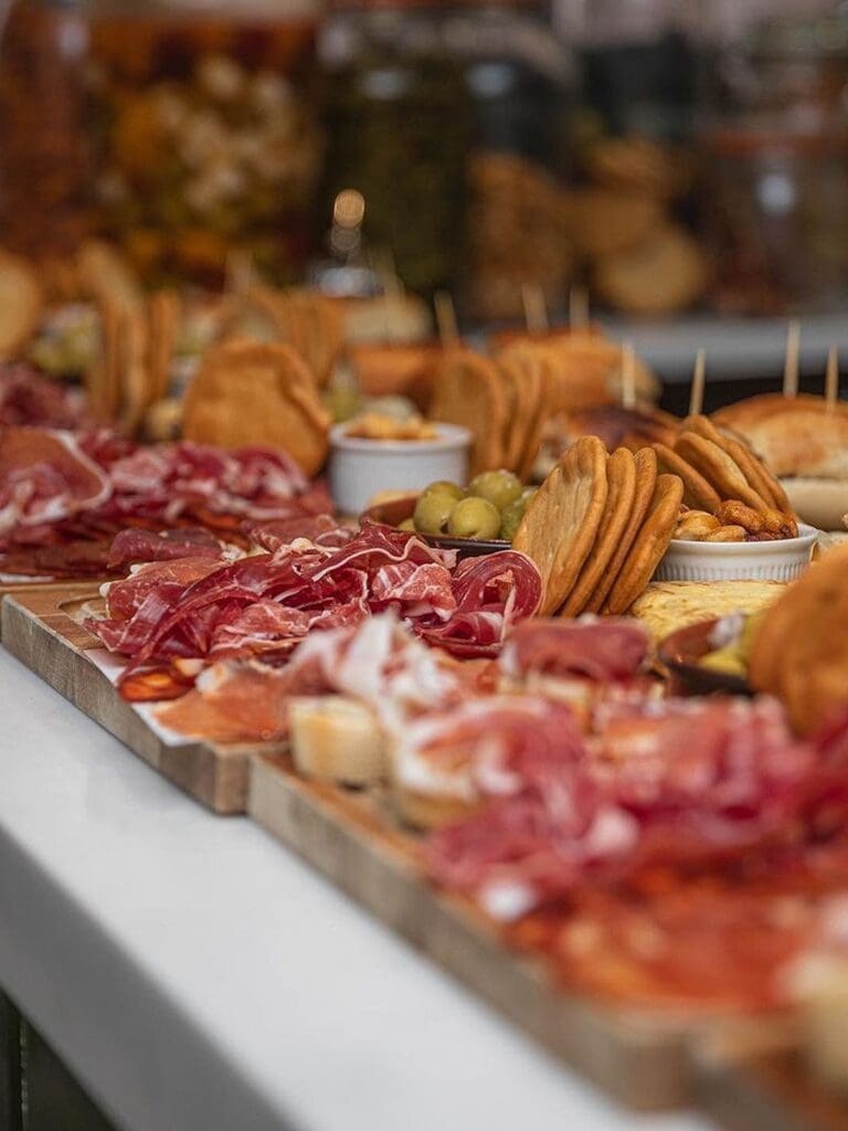 Charcuterie boards piled with cured meats, crackers and olives at Bobo’s Wine Bar, ideal for hen weekend grazing.