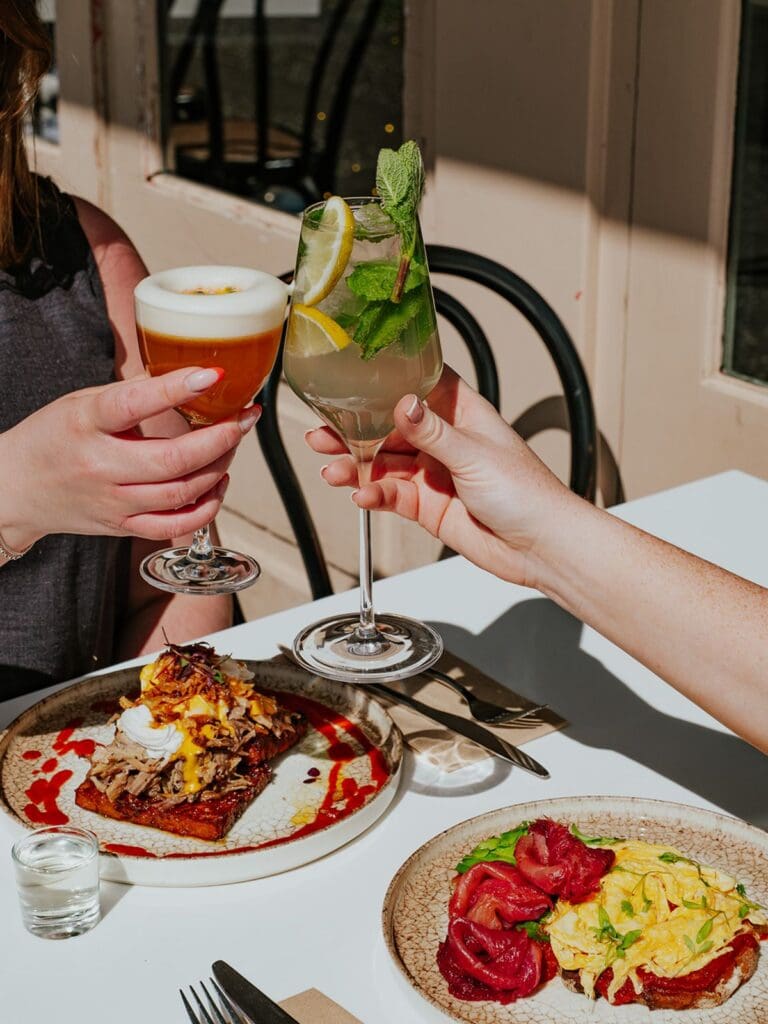 Cocktails clinking over sunny brunch plates at CASA Glasgow, an easy hen weekend start with food and drinks.