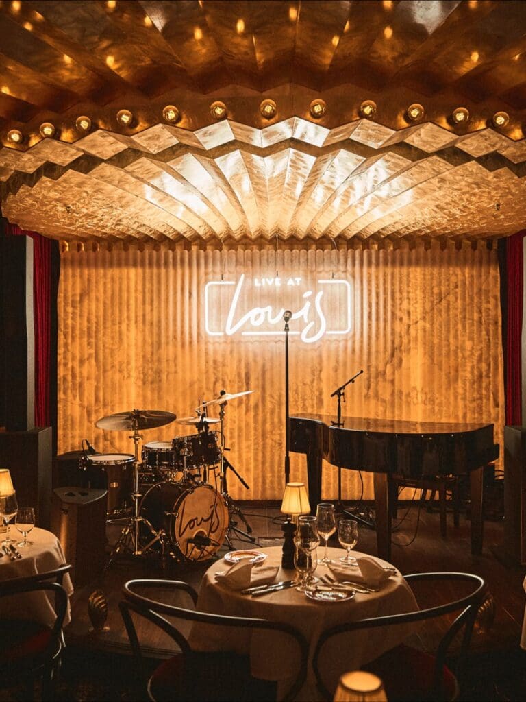 Louis Manchester interior in Spinningfields, featuring warm low lighting, luxe booths and a dressed-up vibe for a girls’ weekend