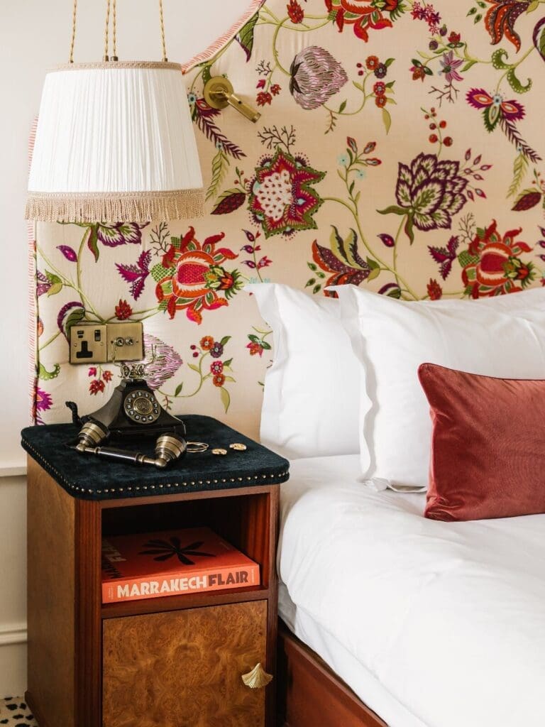 The Leinster Dublin hotel room with plush bedding, colourful decor and layered cushions.