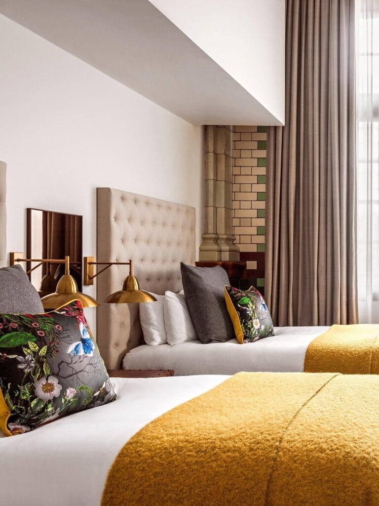 Bedroom at Kimpton Clocktower Manchester with plush bed, classic detailing and warm lighting for a luxe hen stay