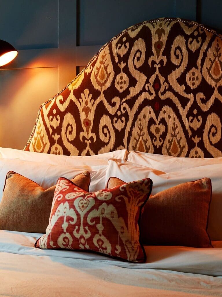 Bedroom at King Street Townhouse Manchester with plush bed, classic detailing and warm lighting for a luxe hen stay