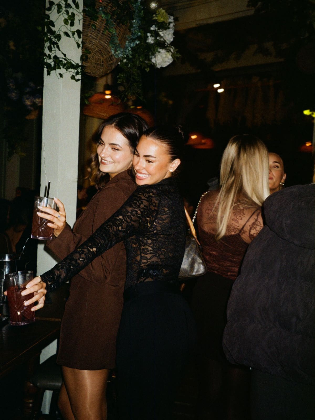 Two girls clink cocktails at bottomless brunch at the prince in London.