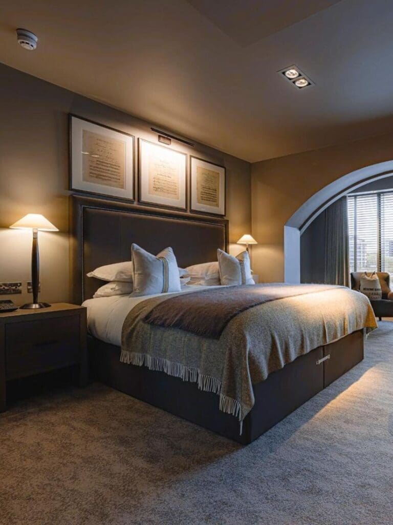Dakota Newcastle bedroom with crisp linens and dark, expensive styling — calm getting-ready base for a hen weekend