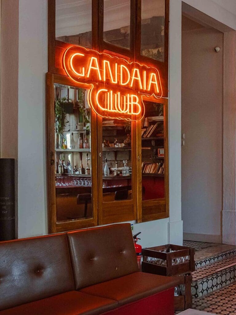 Neon Gandaia Club sign in Lisbon glowing above the entrance, ideal for a late-night hen weekend dinner.