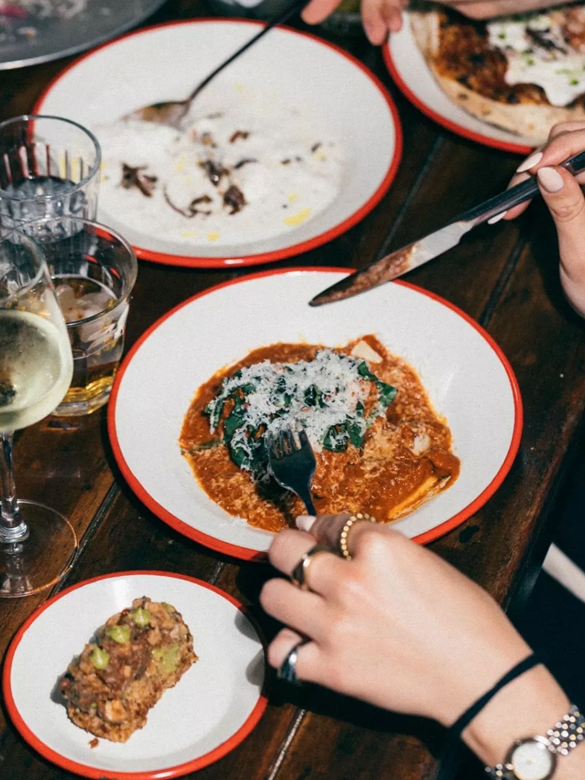 Rich tomato pasta topped with parmesan at Leonetta in Lisbon, part of a vibey girls’ night dinner spread.