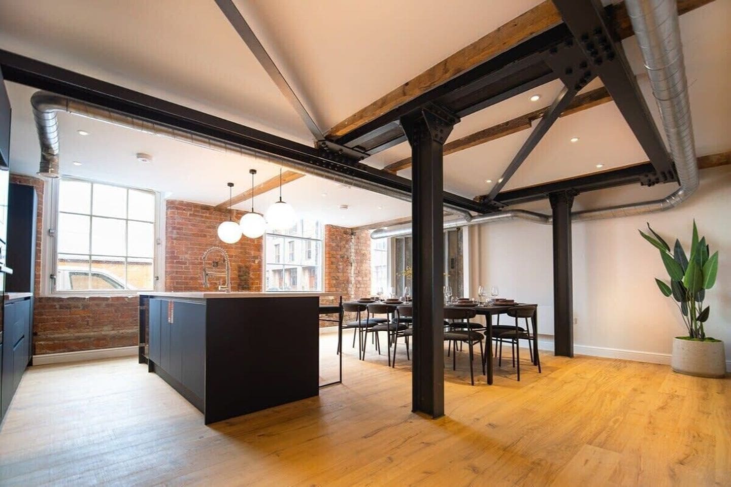Spacious duplex Airbnb in Ancoats with pool table and large sofa, ideal for a Manchester hen weekend with social living space.
