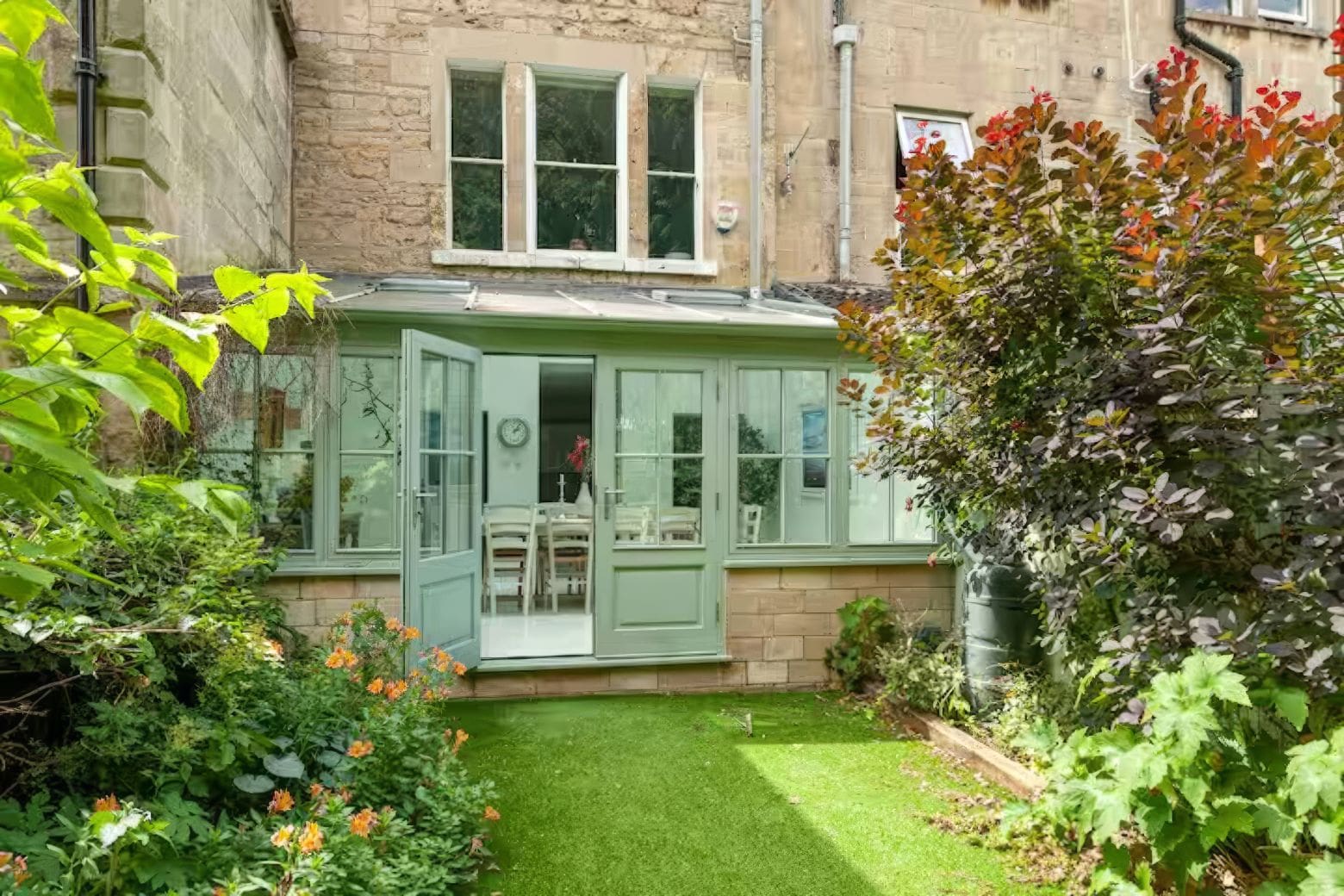 Bright orangery with seating and garden views in Airbnbs in Bath for a hen weekend.