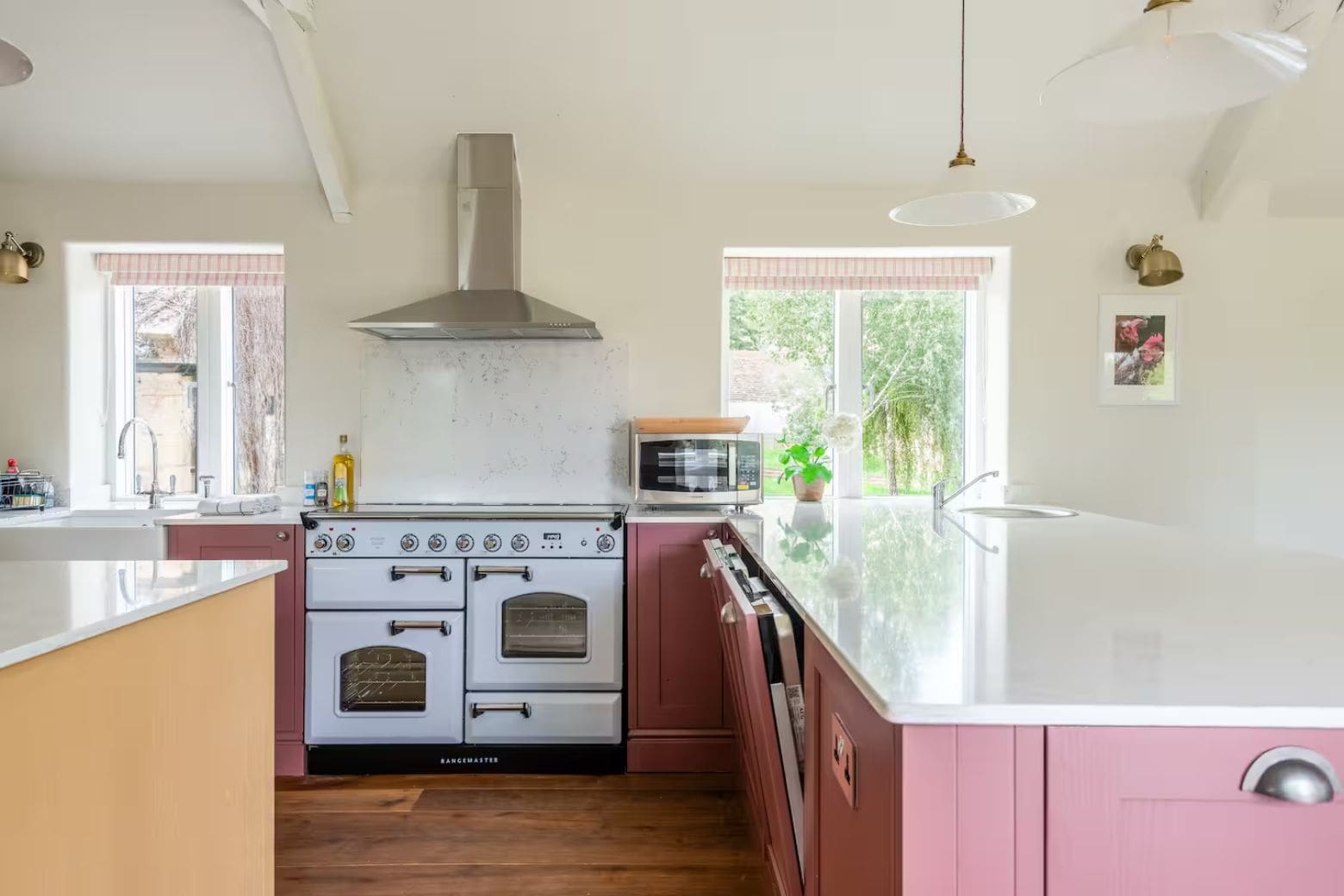 Rustic farmhouse kitchen with long dining table and wood-burning stove in Airbnbs in Bath for a hen weekend.