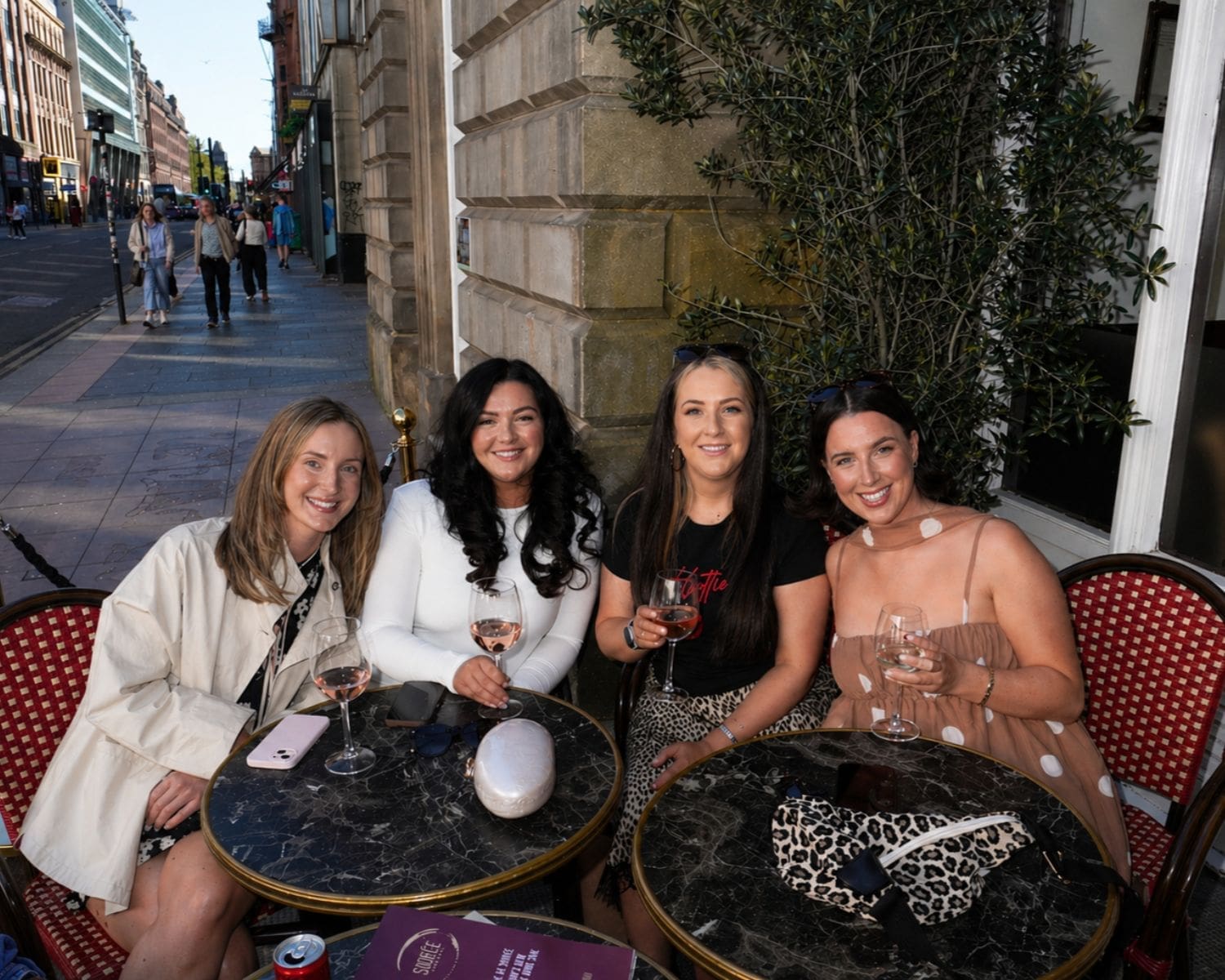 Alfresco drinks at Soiree during a Glasgow hen weekend, where a simple glass of wine turns into hours of chatting — peak girls trip energy with the bride to be.