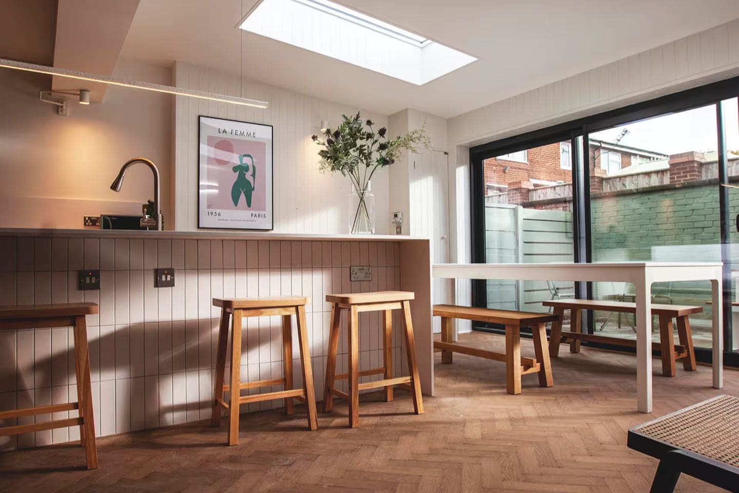Bright birch ply kitchen island in a Manchester city centre Airbnb, ideal for a hen weekend with drinks, snacks and everyone gathered round.