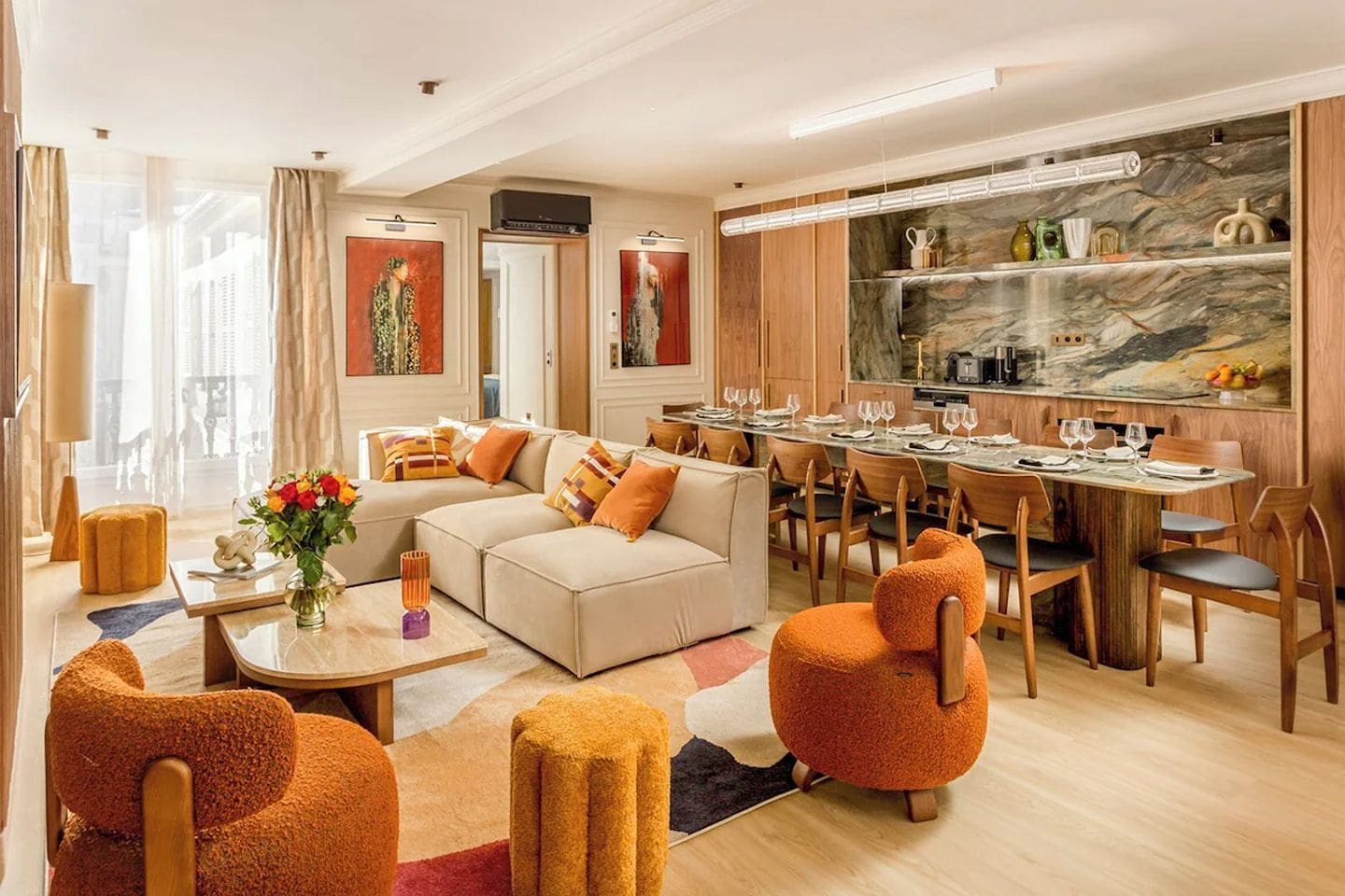 Luxury group apartment in Le Marais Paris with marble dining table, open-plan living area and warm contemporary interiors, perfect for a Paris hen weekend