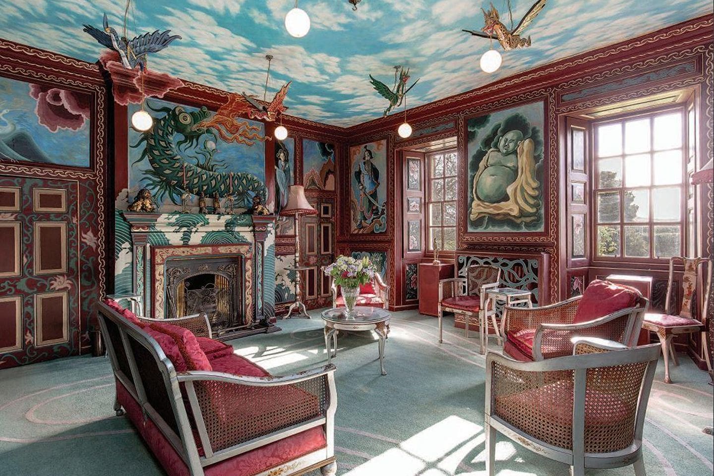 Maximalist drawing room at Monkton House near Edinburgh with hand-painted walls, ornate fireplace and eclectic interiors, perfect for a unique group stay