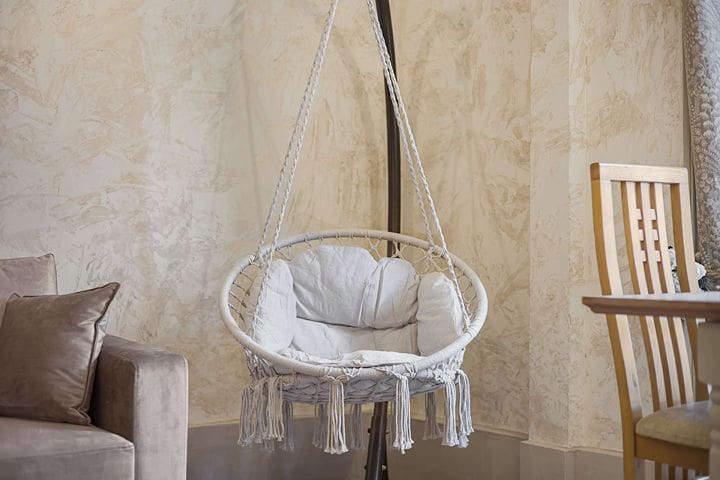 A slightly chaotic but perfect corner for a Brighton Airbnb hen weekend — this hanging chair will get claimed fast