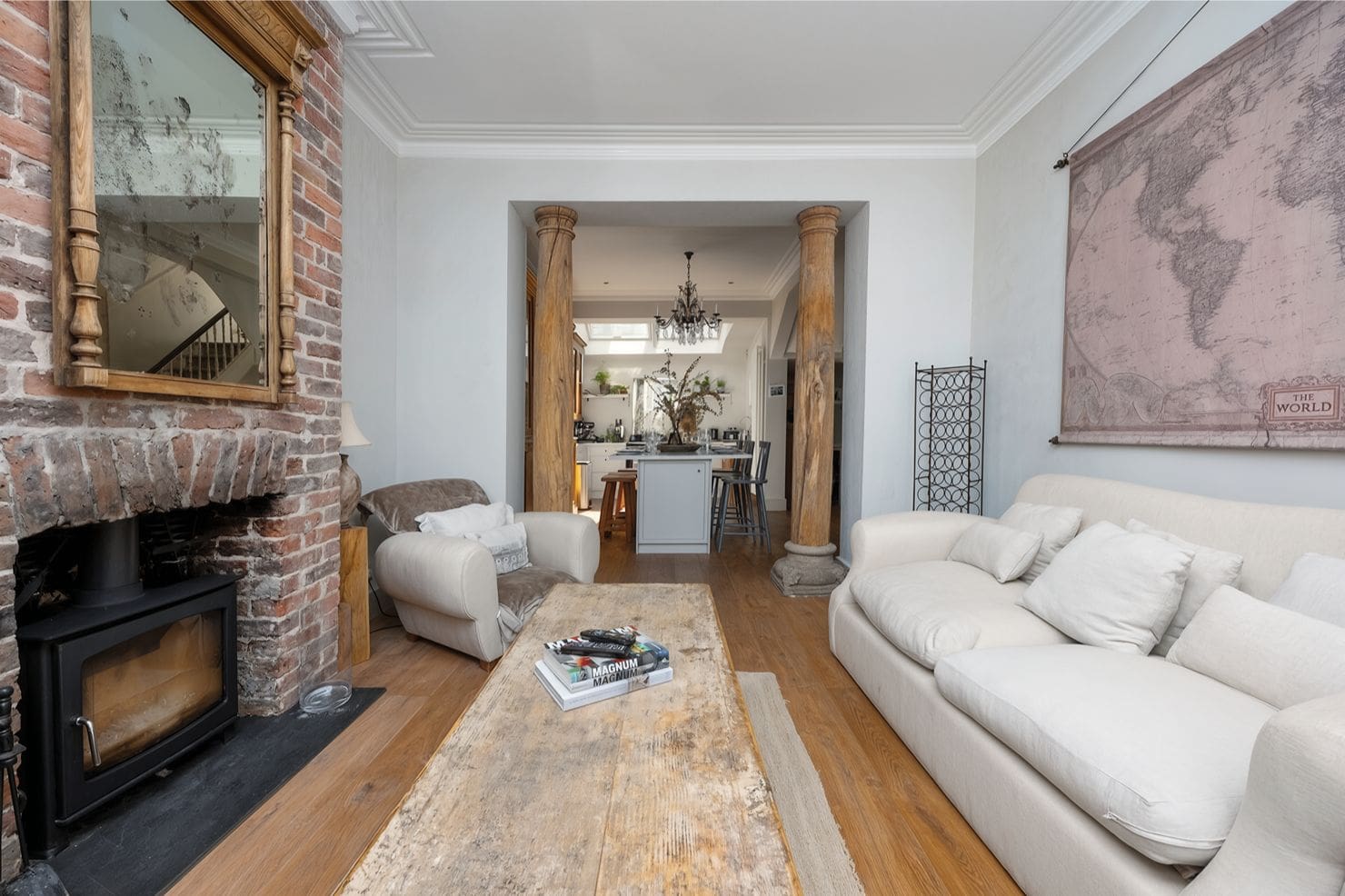 Bright open-plan living room with fireplace and large sofas in Walpole House Brighton, ideal for hen weekend group stays