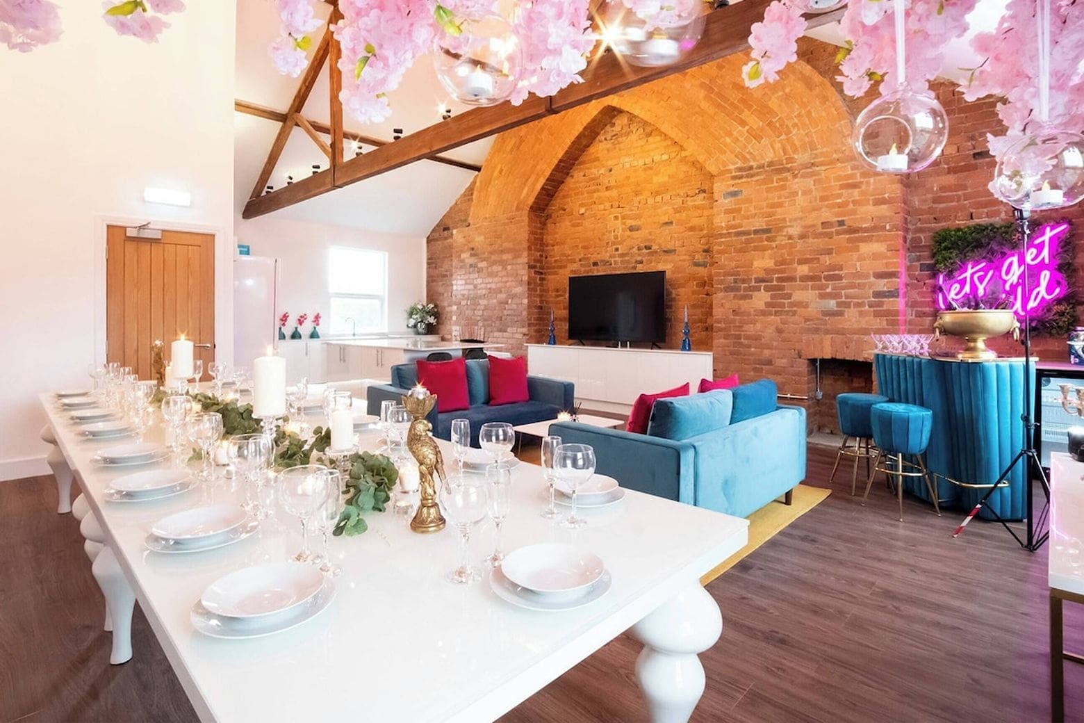 Bold colourful interiors with neon sign and karaoke space in Airbnbs in York for a hen weekend designed for group celebrations.