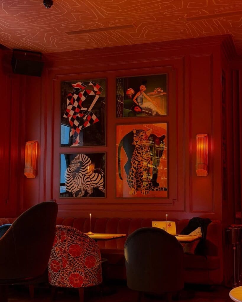 Red lounge seating inside Collins Club at The Leinster hotel in Dublin, with bold artwork, soft lamps and a sultry cocktail-bar feel for a girls’ night out in Dublin.
