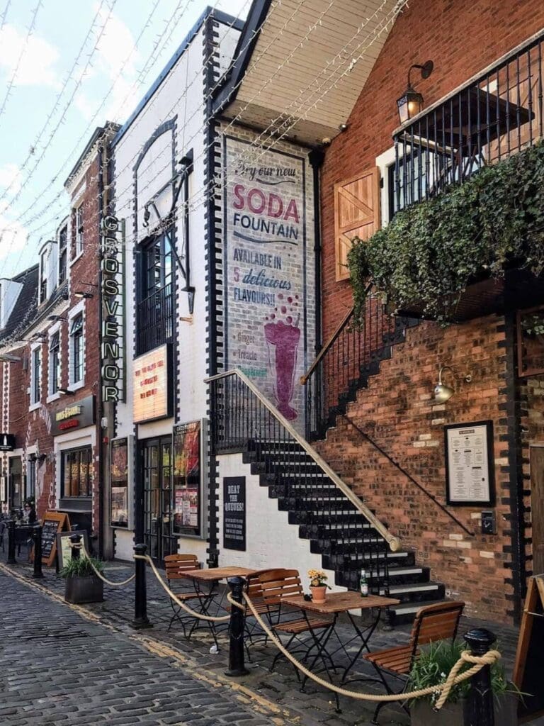 Ashton Lane in Glasgow’s West End, with cobbled streets, bars, outdoor seating and fairy lights, featured as inspiration for Glasgow hen do activities.