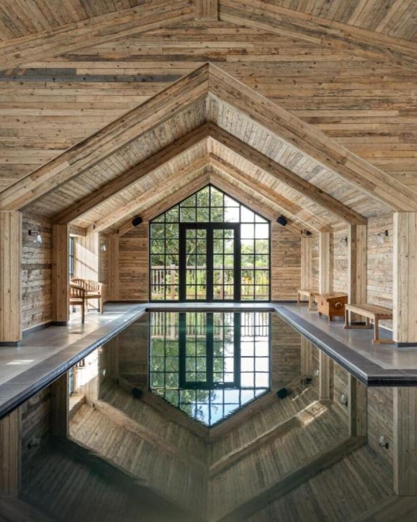 Indoor swimming pool at Louma Farm & Retreat with vaulted wooden ceilings and spa-style interiors — a luxury countryside retreat for hen weekends, girls’ trips and group stays in Dorset.