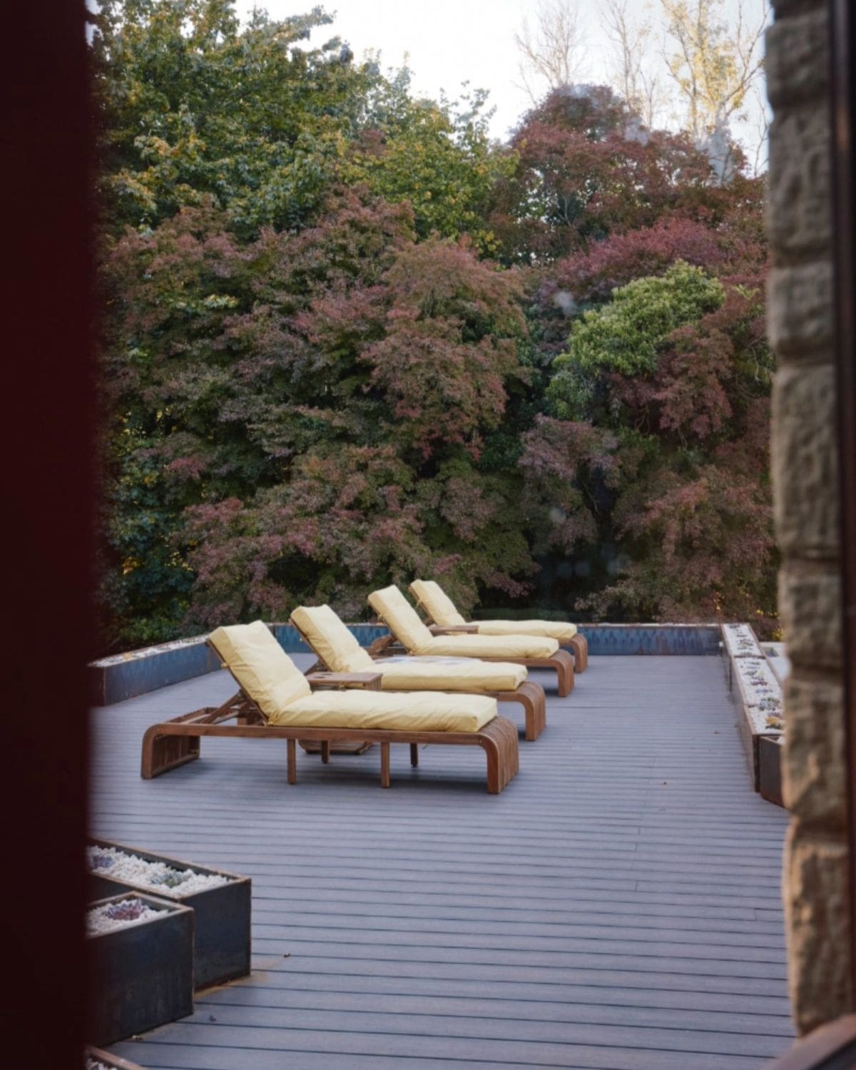 Outdoor spa terrace at Villa Vista with reclining loungers and leafy countryside surroundings — a peaceful luxury retreat for a relaxed hen weekend, girls’ getaway or group stay.