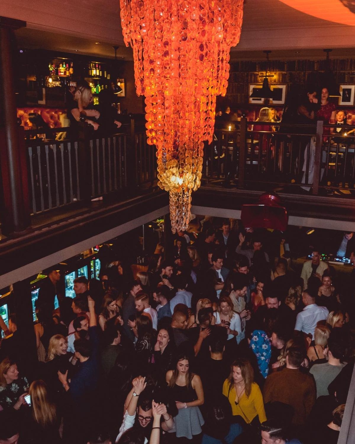 Busy dance floor at No 32 in Brighton, with a statement chandelier overhead and crowds filling the late-night bar during a Brighton hen weekend.