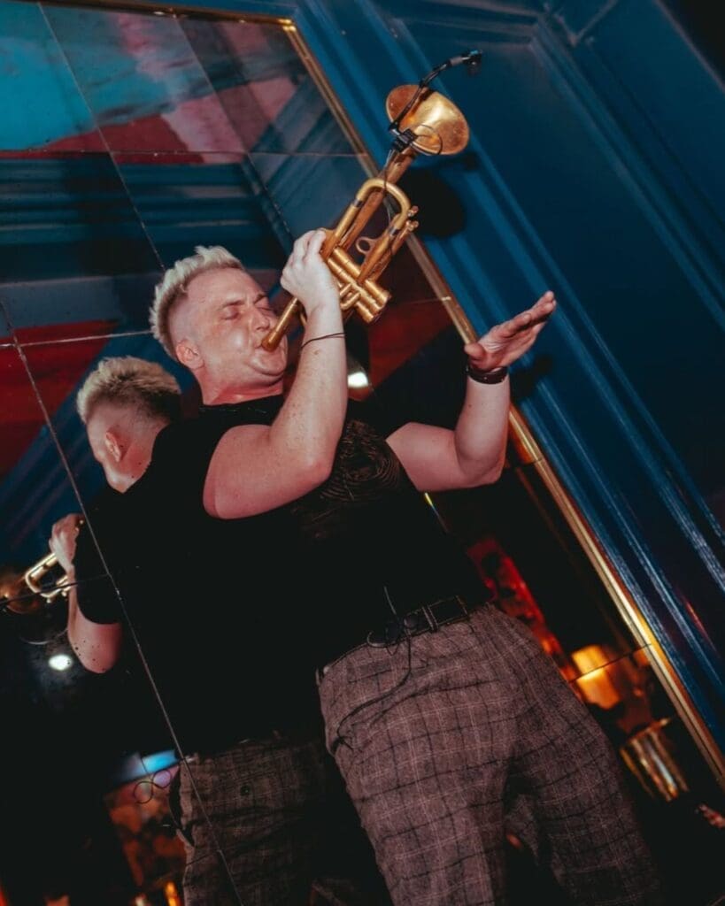 A live trumpet player performing inside NoLIta Dublin, capturing the high-energy atmosphere of the late-night bar and party spot for a Dublin hen weekend.