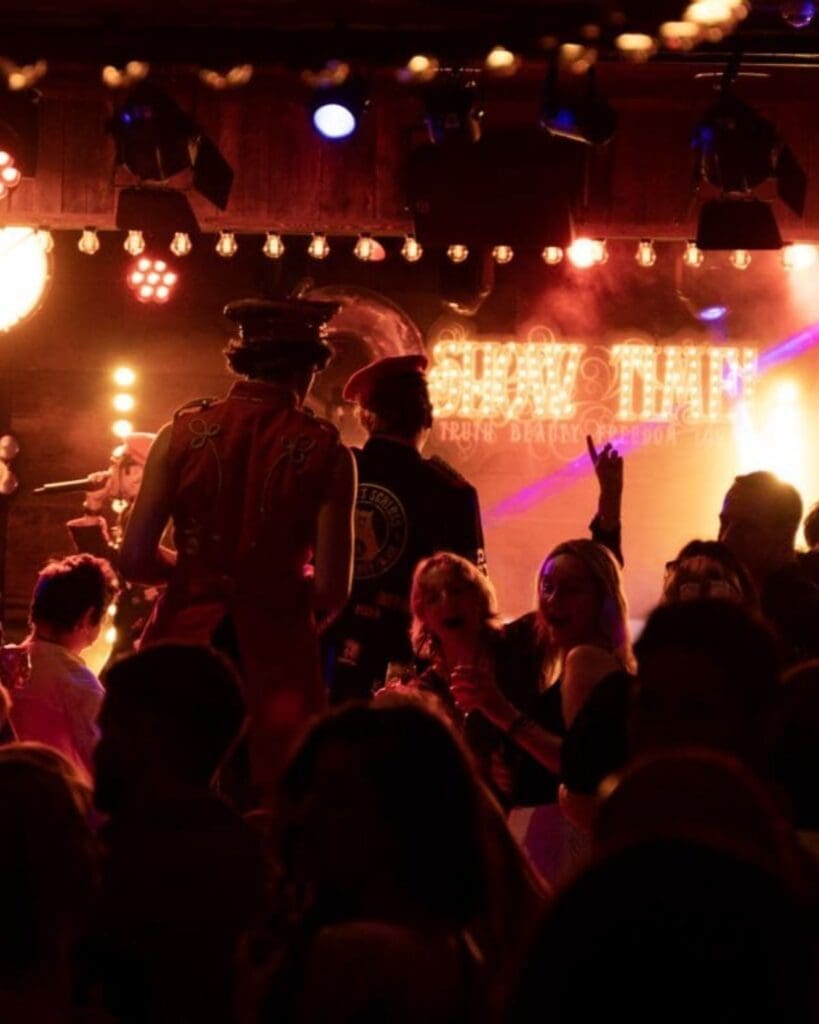 A packed evening at Albert’s Schloss in Manchester, with live performers moving through the crowd beneath glowing stage lights — a high-energy choice for going out-out on a Manchester hen weekend.