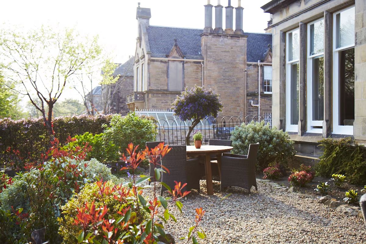 Garden terrace at The Roseate Edinburgh, an elegant Edinburgh hen weekend hotel with leafy outdoor seating and a peaceful residential setting.