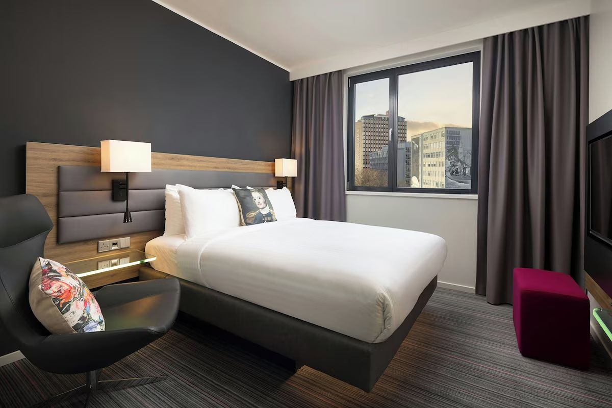 Modern bedroom at Moxy Glasgow Merchant City, a Glasgow hen weekend hotel with clean contemporary styling, city views and colourful design touches.
