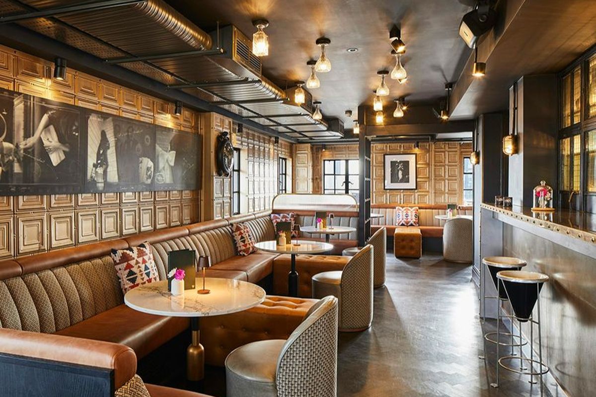 Stylish lounge and bar at The Rex Newcastle with leather seating and dramatic contemporary interiors.