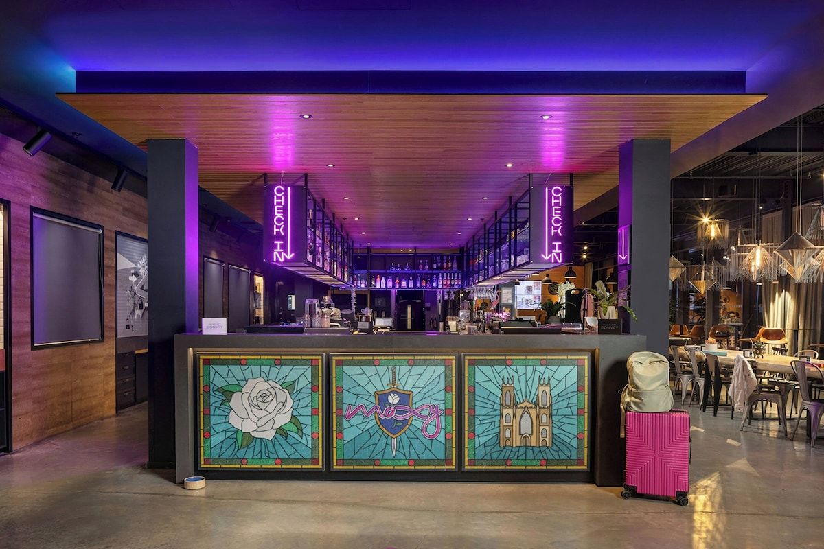 Lobby bar at Moxy York, a sociable York hen weekend hotel with colourful seating and plenty of space for groups to meet downstairs
