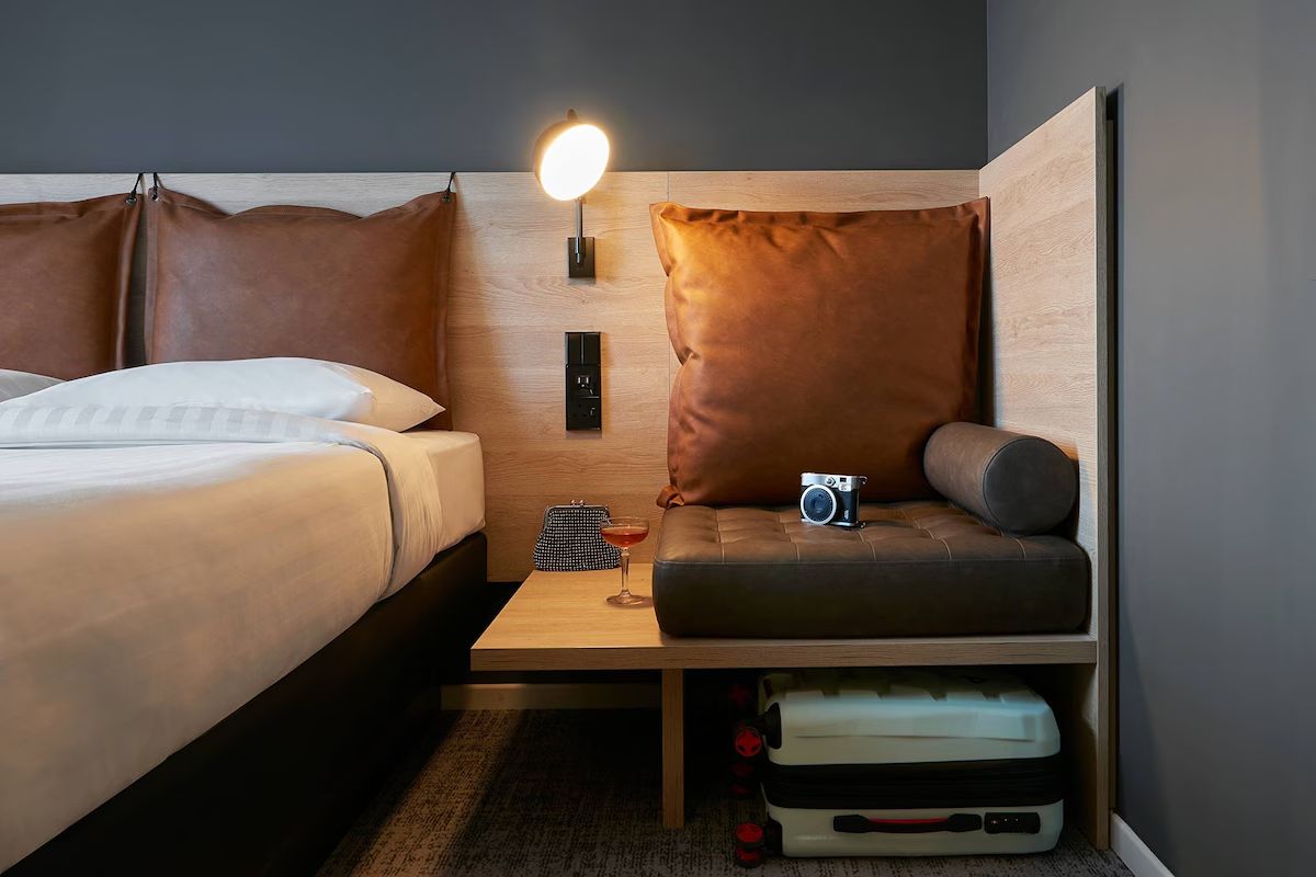 Bedroom at Moxy Edinburgh Fountainbridge, a modern Edinburgh hen weekend hotel with smart storage and contemporary styling.
