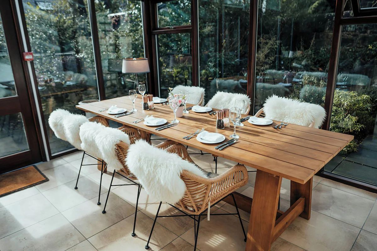Bright dining room at The Roseate Edinburgh, an Edinburgh hen weekend hotel with garden views, natural wood furniture and cosy sheepskin seating.