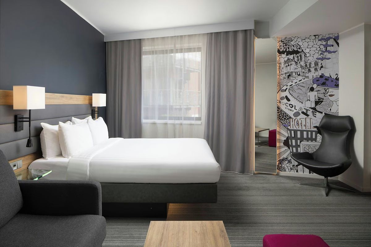 Bedroom at Moxy York, a modern York hen weekend hotel with compact interiors and clever storage.