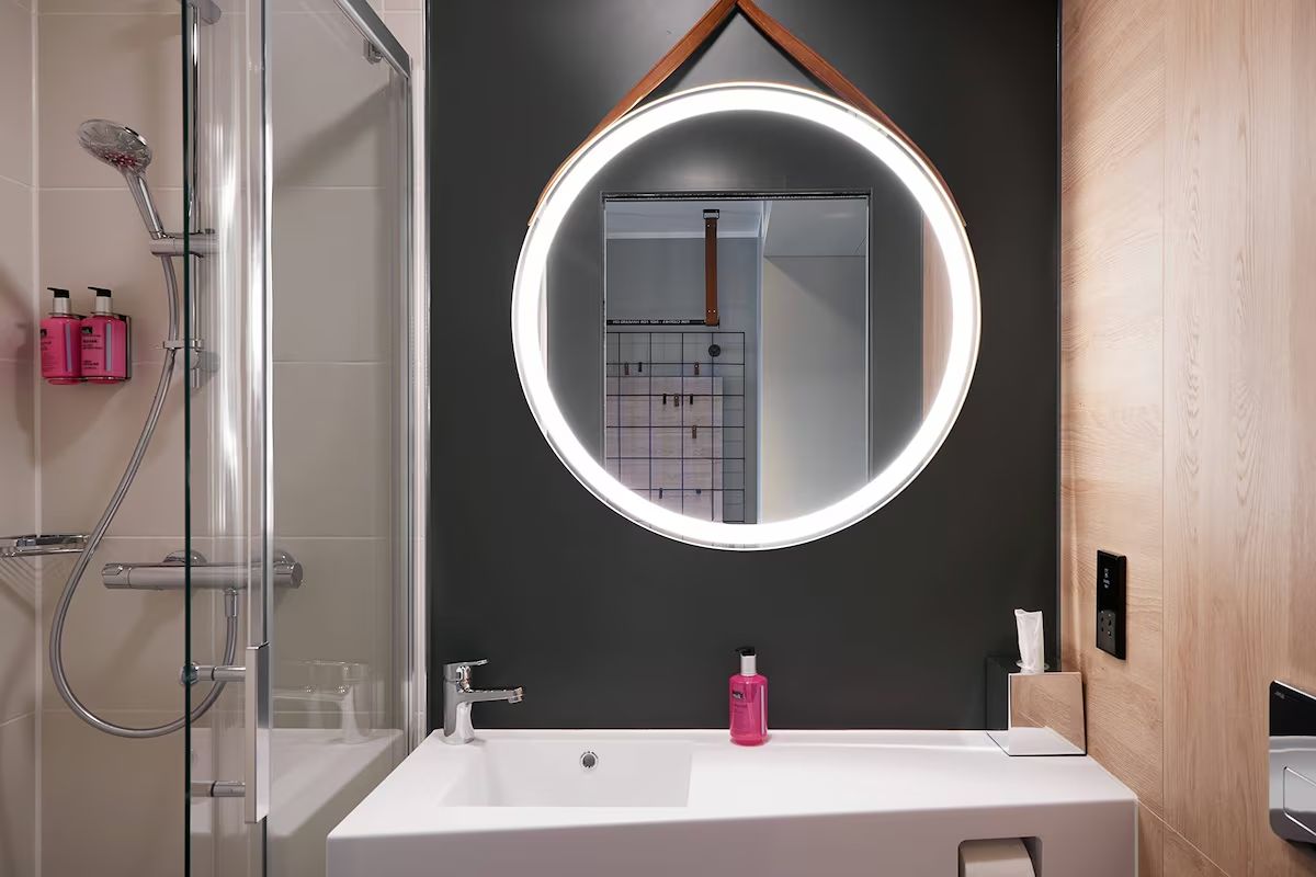 Bathroom at Moxy Edinburgh Fountainbridge with a modern walk-in shower and clean contemporary finishes.