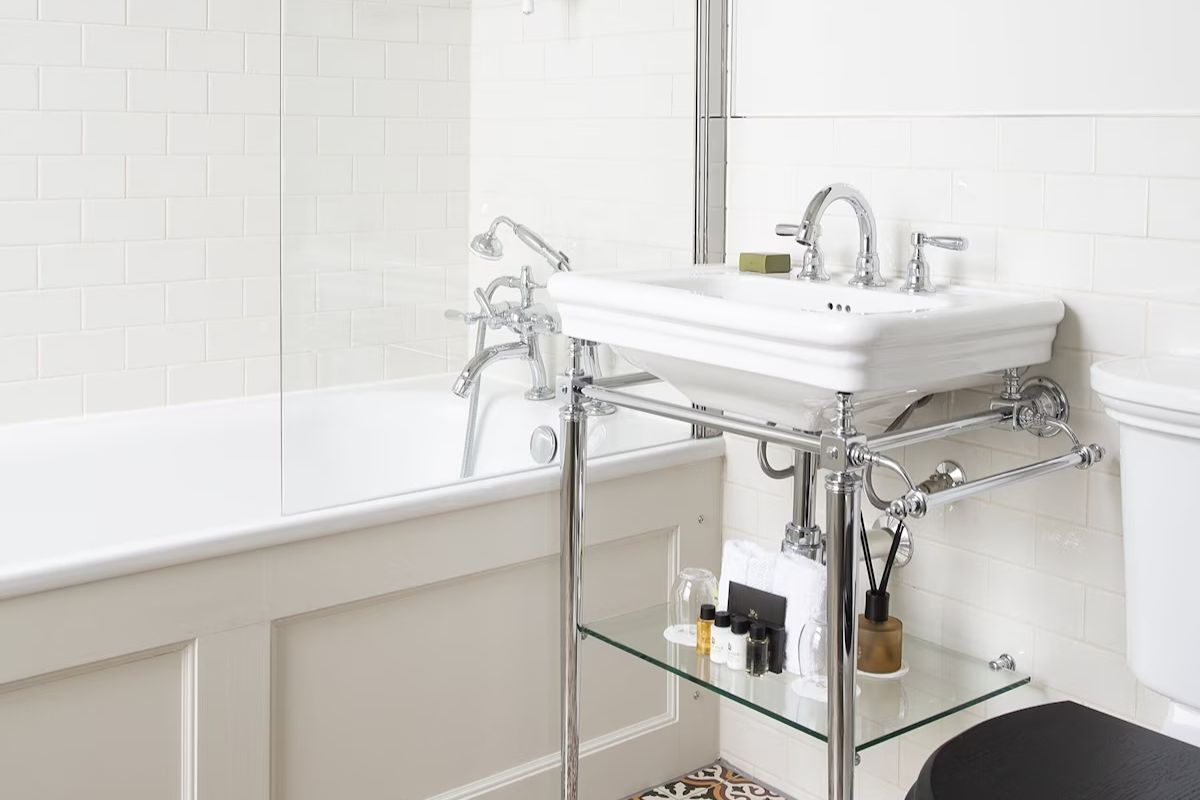 Classic bathroom at The Roseate Edinburgh, a boutique Edinburgh hen weekend hotel with white metro tiles, chrome fittings and traditional details.