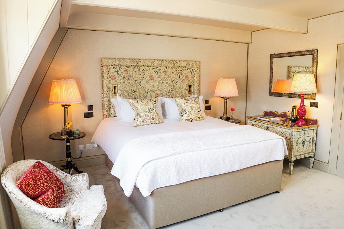 Elegant bedroom at Dukes Bath with floral wallpaper and classic boutique styling.