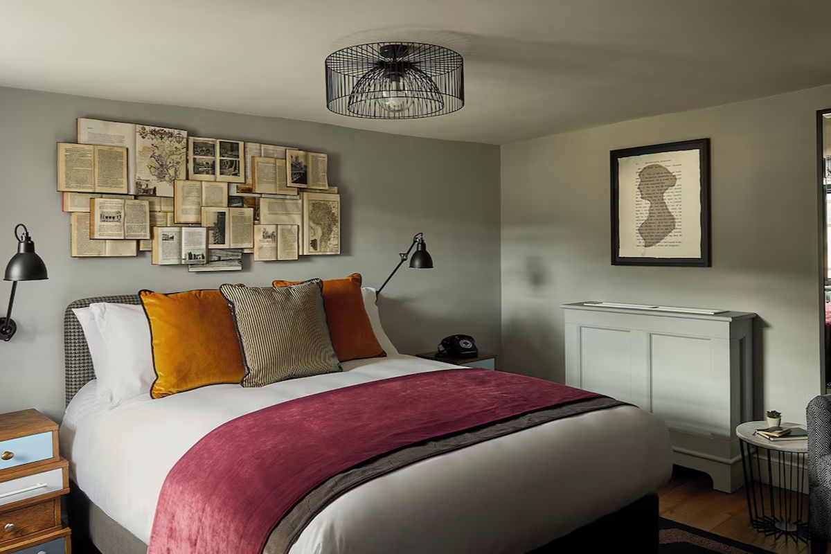 Contemporary bedroom at Hotel Indigo Bath, a stylish Bath hen weekend hotel with modern furnishings, rich colours and quirky decorative details.