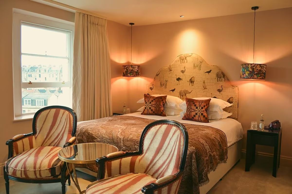 Stylish bedroom at The Bird, a colourful Bath hen weekend hotel with boutique interiors.