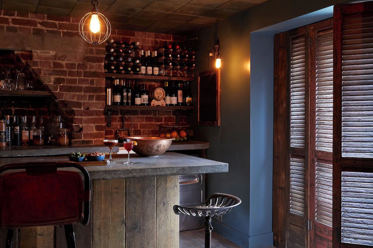 Rustic bar at Artist Residence Brighton, a stylish Brighton hen weekend hotel with exposed brick walls, cosy lighting and a relaxed atmosphere.