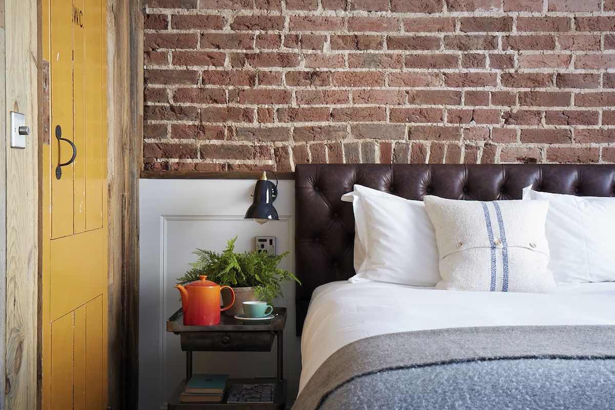 Boutique bedroom at Artist Residence Brighton, a Brighton hen weekend hotel with exposed brick, vintage details and colourful touches.