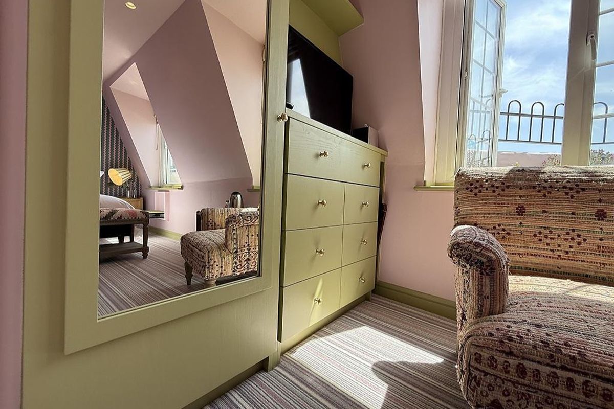 Cosy bedroom seating area at Drakes of Brighton, a characterful Brighton hen weekend hotel with pastel interiors and natural light.