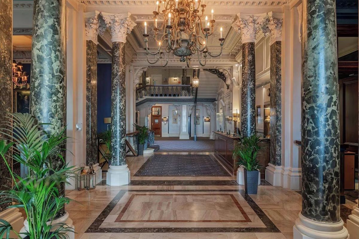 Grand hotel lobby at The Grand Brighton, a luxury Brighton hen weekend hotel with marble columns, chandeliers and elegant period details.