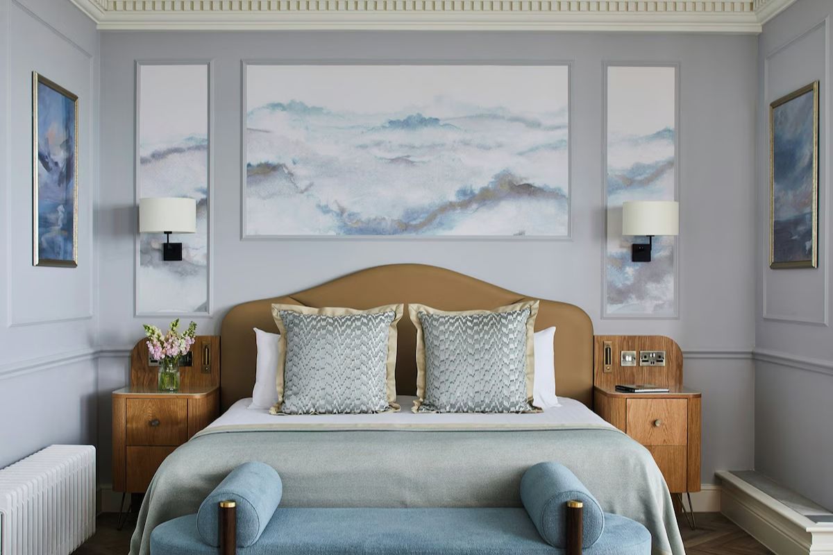 Stylish bedroom at The Grand Brighton, a luxury Brighton hen weekend hotel with soft blue tones, elegant panelling and contemporary furnishings.