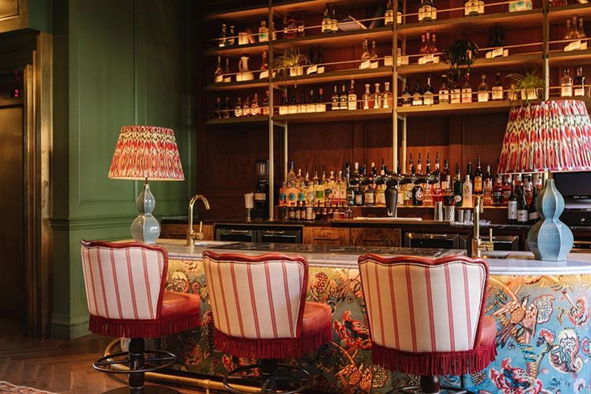 Bar at The Dean Dublin, a lively Dublin hen weekend hotel with dark green walls, patterned seating and a statement cocktail bar.