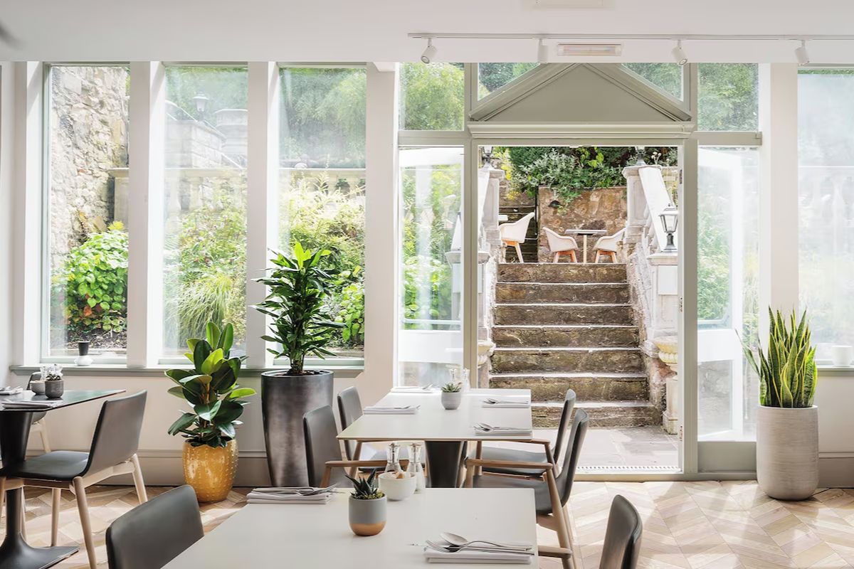 Bright restaurant at voco Edinburgh – Royal Terrace, an Edinburgh hen weekend hotel with modern dining spaces opening towards the garden.